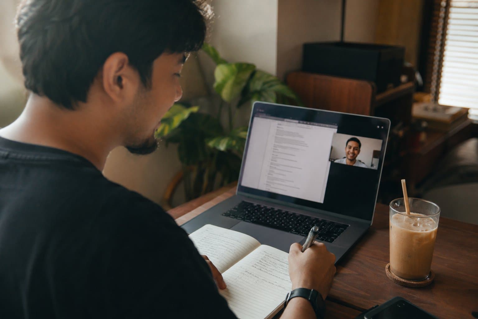 Creator taking notes during a video-call briefing